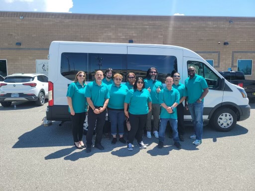 The Medi-Connect team standing together in front of a transport van